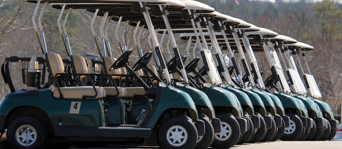 A bunch of golf carts parked | Breast Cancer Car Donations