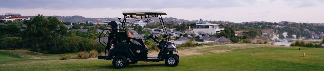 Black Golf Cart on Green Grass Field | Breast Cancer Car Donations