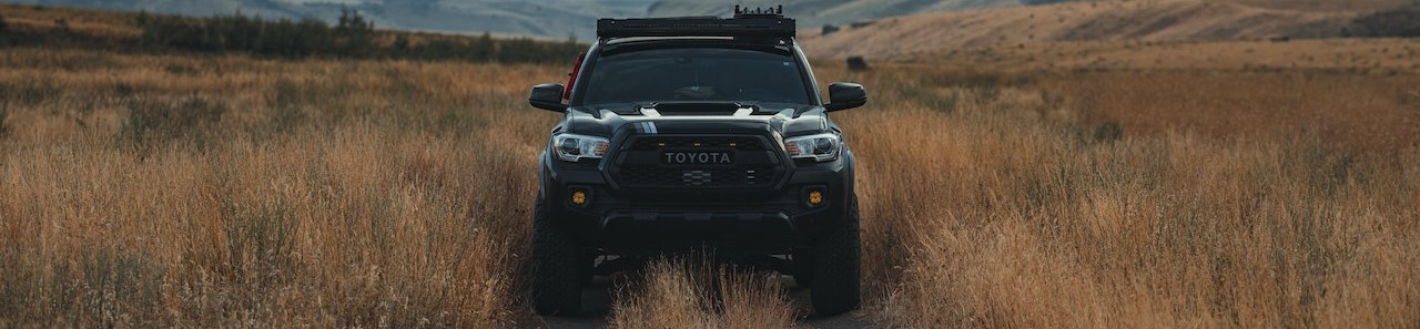 Black Pickup Truck on Brown Grass Field | Breast Cancer Car Donations