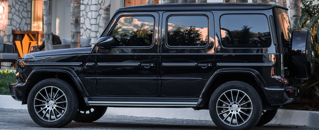 Black SUV Parked Beside the Palm Trees | Breast Cancer Car Donations