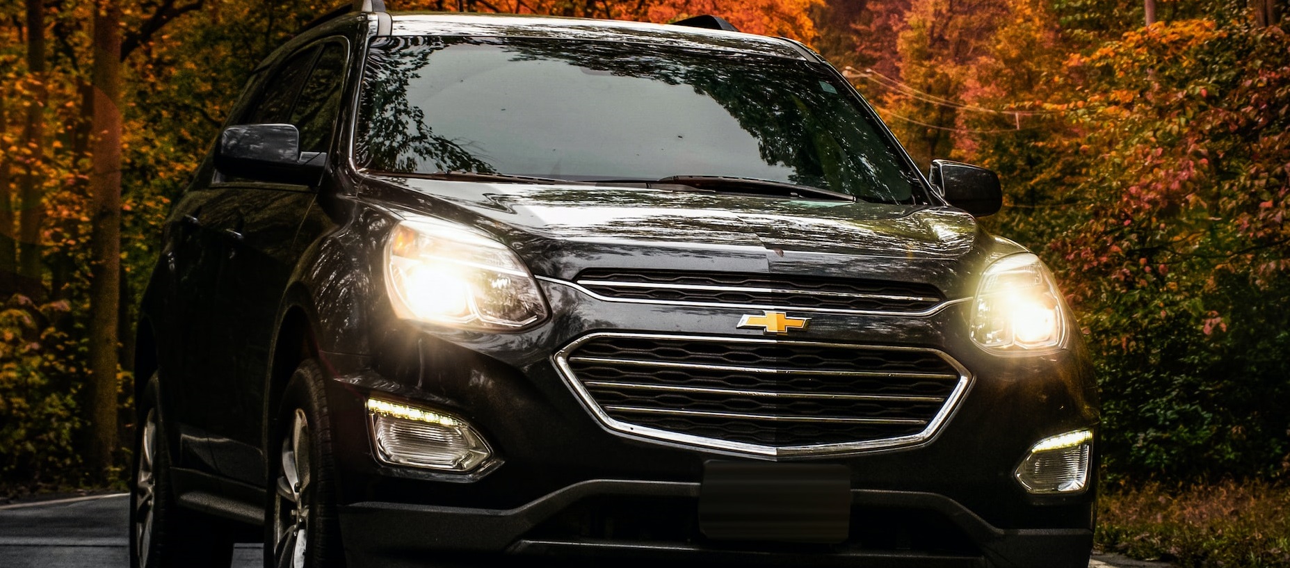 Black SUV parked on road during sunset | Breast Cancer Car Donations