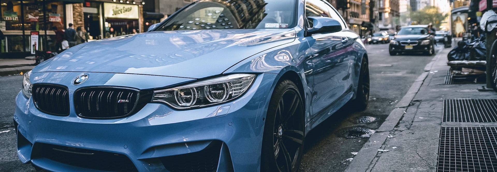 Blue BMW coupe parked on the road during daytime | Breast Cancer Car Donations