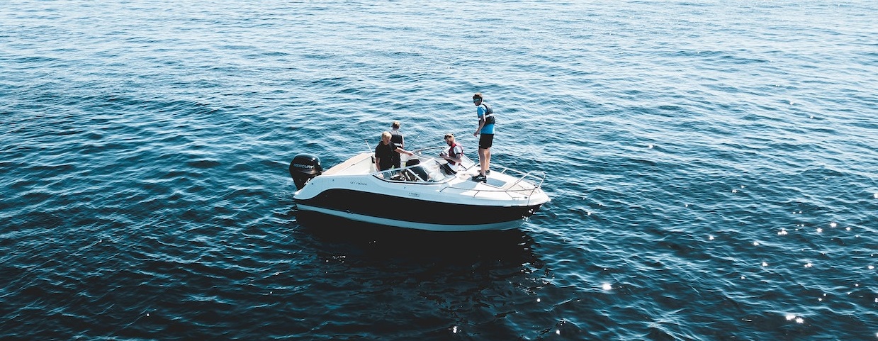 Boat on middle of ocean with people | Breast Cancer Car Donations