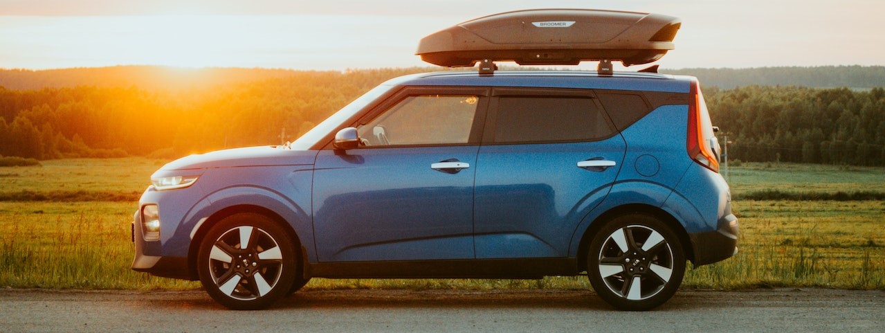 Car with Roof Rack on a Rural Road | Breast Cancer Car Donations