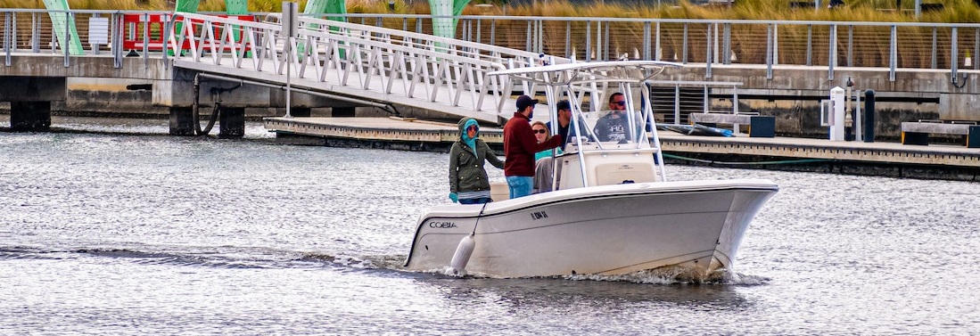 Center Console boat on water with people | Breast Cancer Car Donations