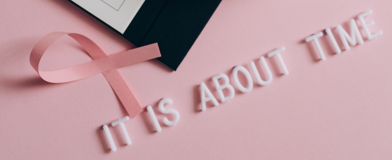 Close-Up Shot of a Pink Ribbon beside a Calendar | Breast Cancer Car Donations