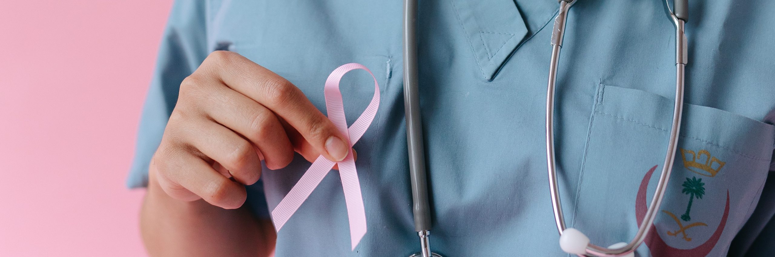Doctor Holding a Pink Ribbon | Breast Cancer Car Donations