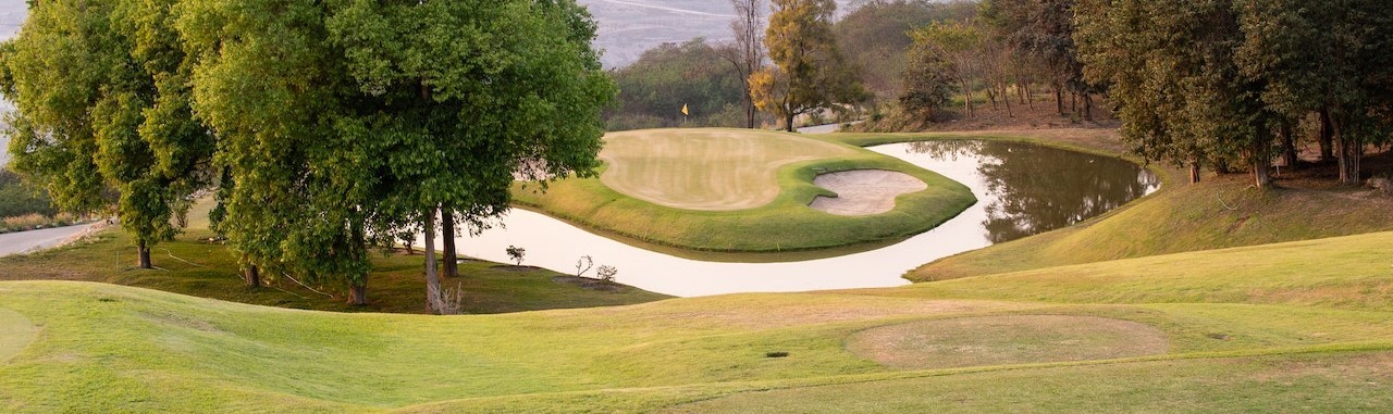 Golf Course in Green Grass Field With Trees | Breast Cancer Car Donations