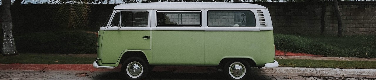 Green and white volkswagen van near a coconut tree | Breast Cancer Car Donations