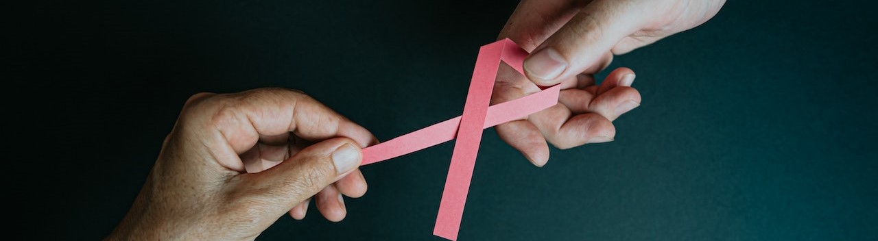 Hands Holding Breast Cancer Pink Paper Ribbon | Breast Cancer Car Donations