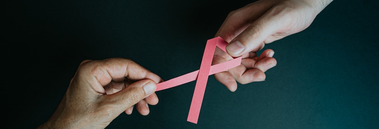 Hands Holding Breast Cancer Pink Paper Ribbon | Breast Cancer Car Donations