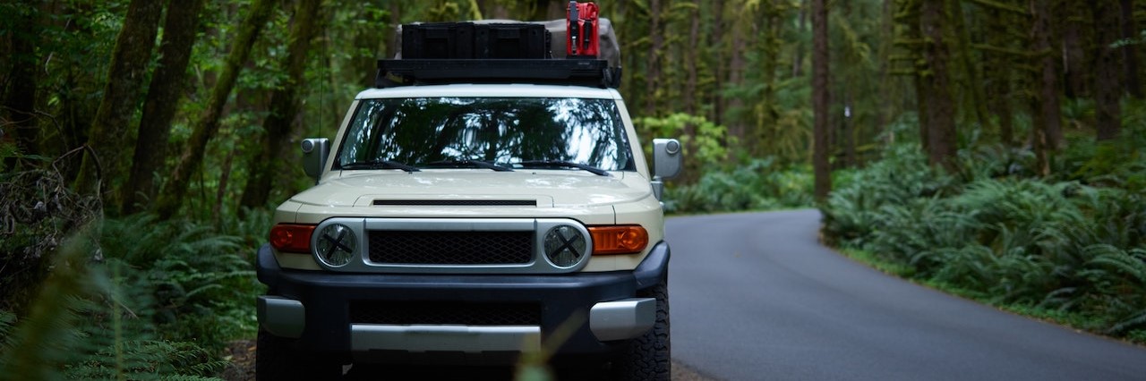 Off road car parked on roadside in forest | Breast Cancer Car Donations