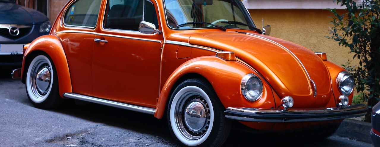 Orange beetle parked on road | Breast Cancer Car Donations