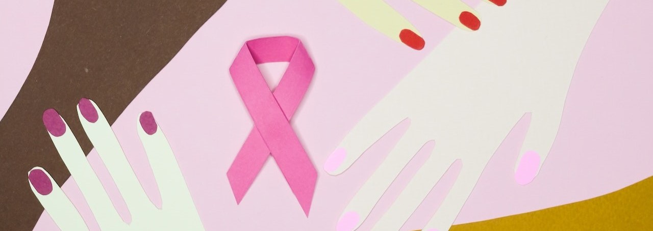 Paper Cutouts of Hands on a Pink Background| Breast Cancer Car Donations