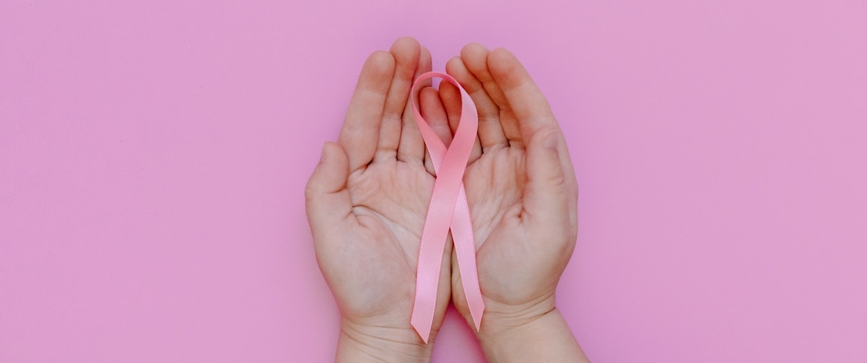 Person Holding Pink Ribbon | Breast Cancer Car Donations