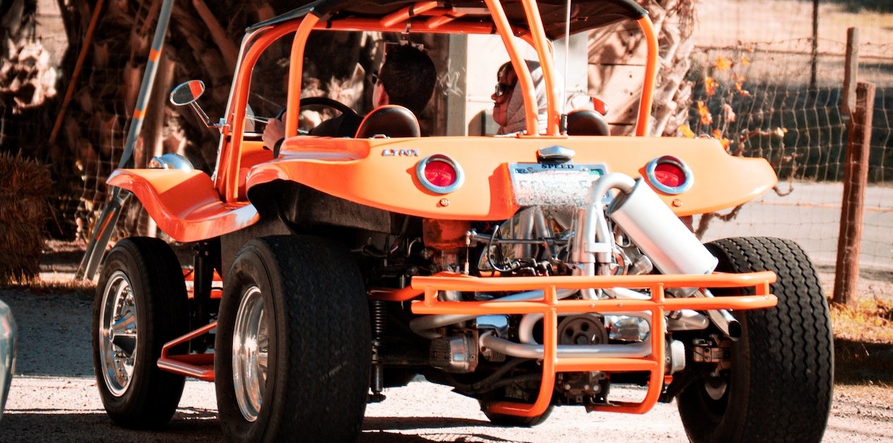 Persons riding orange atv | Breast Cancer Car Donations