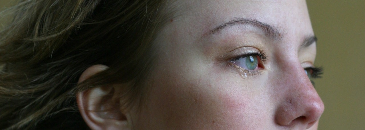 Photo of a woman in tears | Breast Cancer Car Donations