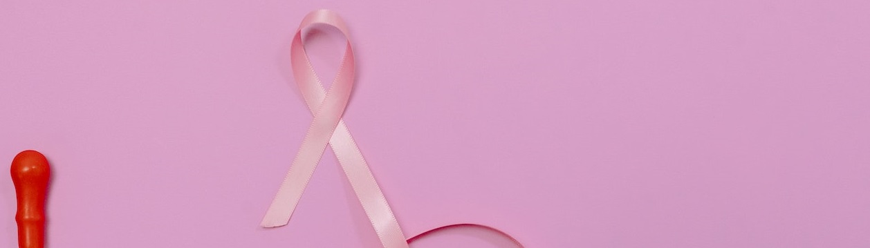 Pinkribbon in pink background | Breast Cancer Car Donations