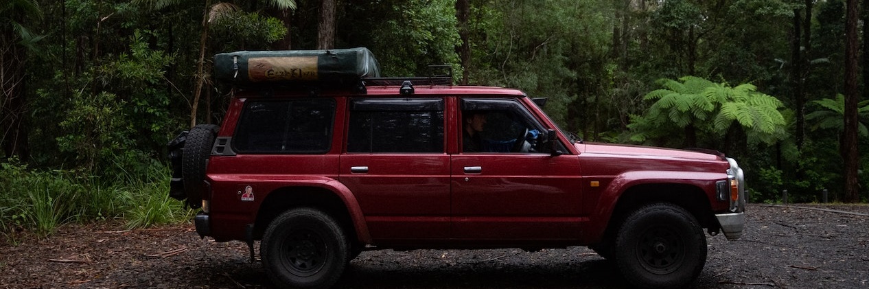 Red Pick up truck in forest | Breast Cancer Car Donations