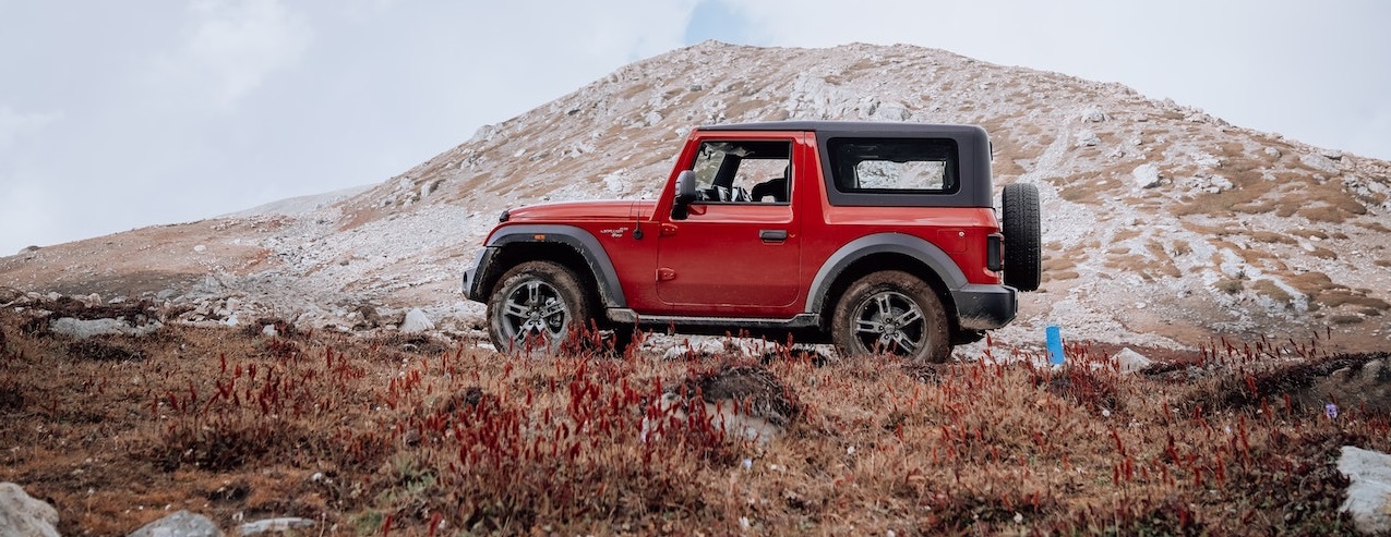 Red SUV parked on mountain