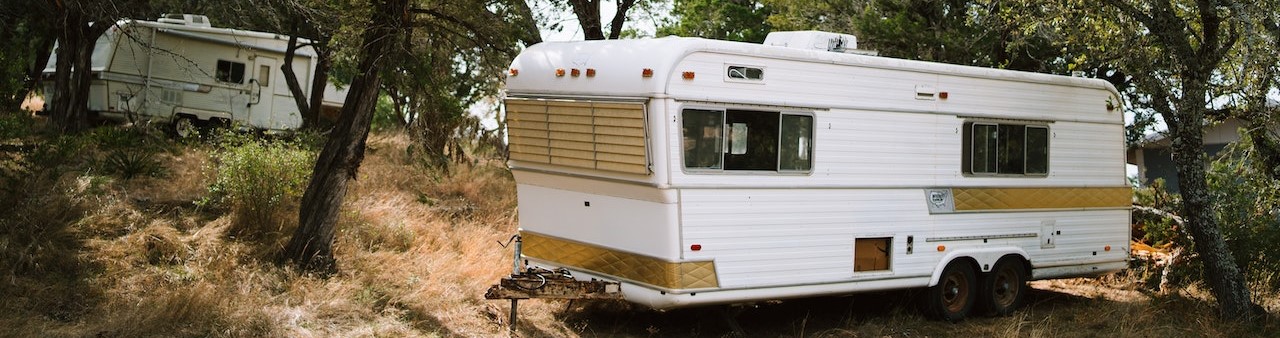 Rv trailker parked at the forest | Breast Cancer Car Donations