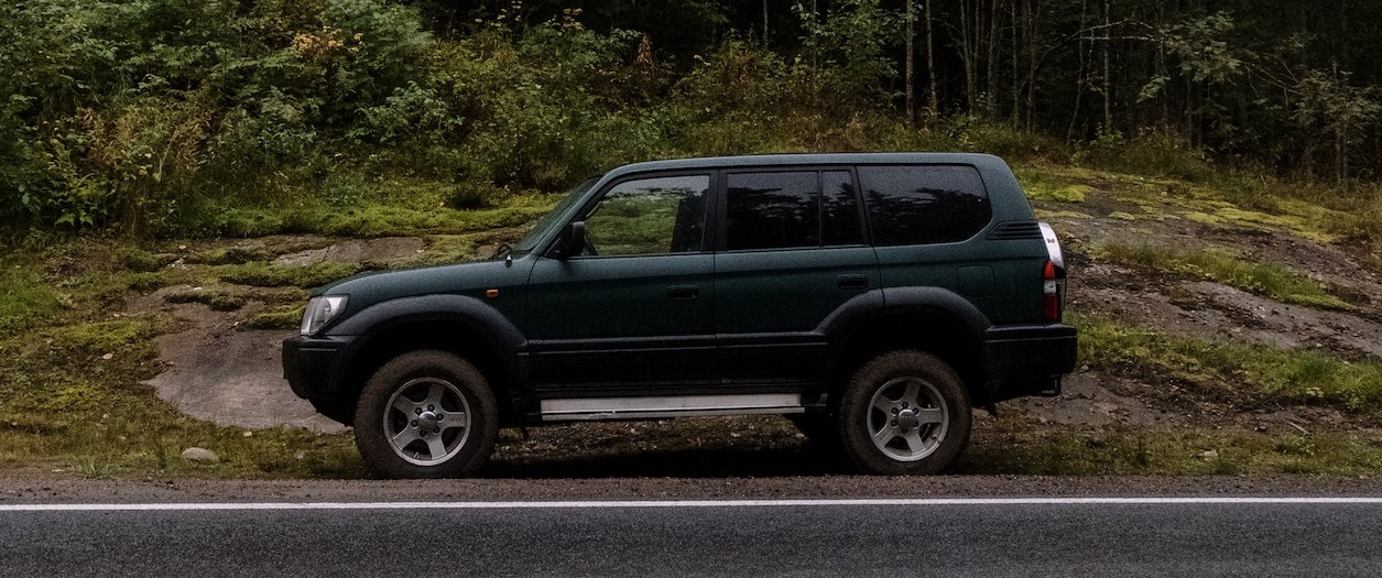 SUV parked on road | Breast Cancer Car Donations