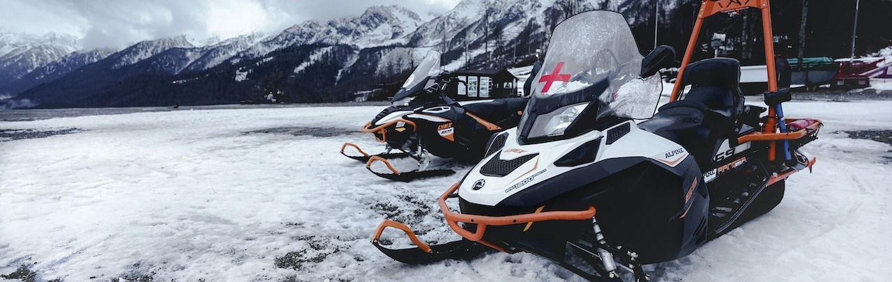 Snowmobile parked in a snowy area | Breast Cancer Car Donations