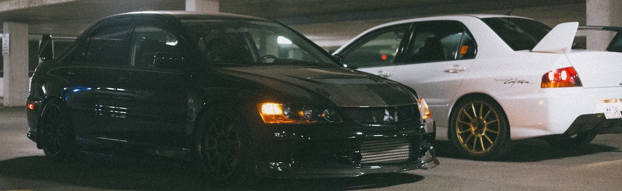 Two Mitsubishi Lancer Evolution Parked Next to Each Other | Breast Cancer Car Donations