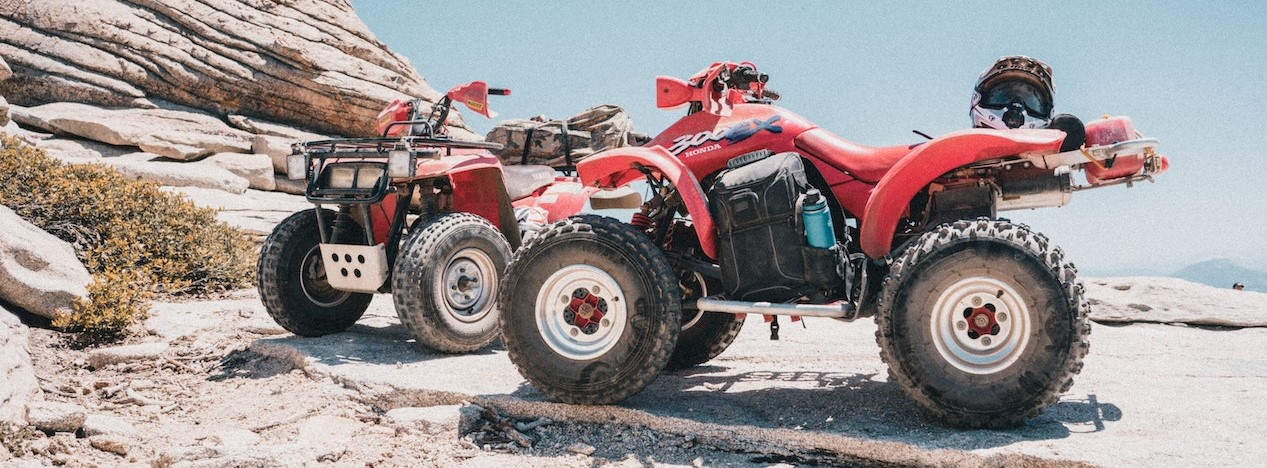 Two Red Atv Parked at the Mountain | Breast Cancer Car Donations