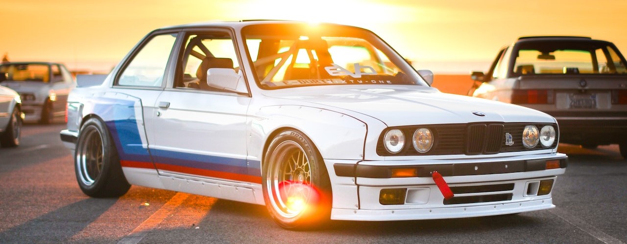 White BMW in the sunset | Breast Cancer Car Donations