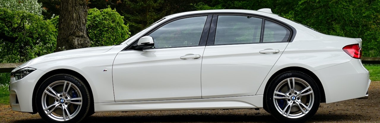 White Bmw Sedan Parked Beside Tree | Breast Cancer Car Donations