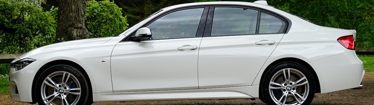 White Bmw Sedan Parked Beside Tree | Breast Cancer Car Donations