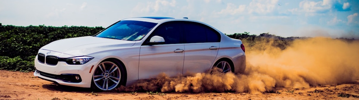 White Car running on sand | Breast Cancer Car Donations