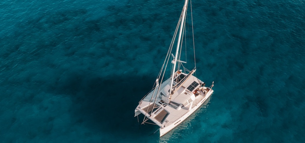 White Catamaran on beach | Breast Cancer Car Donations