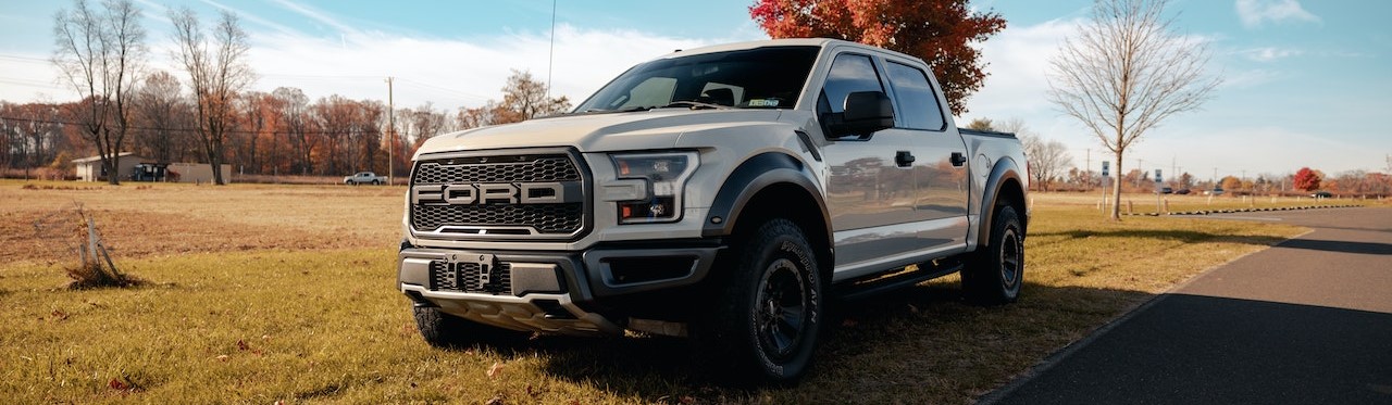 White Ford Pickup Truck on Green Field | Breast Cancer Car Donations