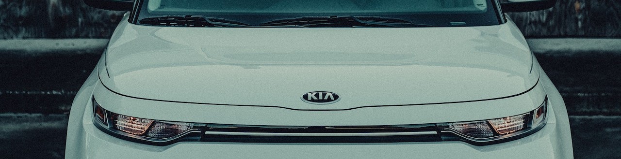 White Kia Car Parked on the Road | Breast Cancer Car Donations