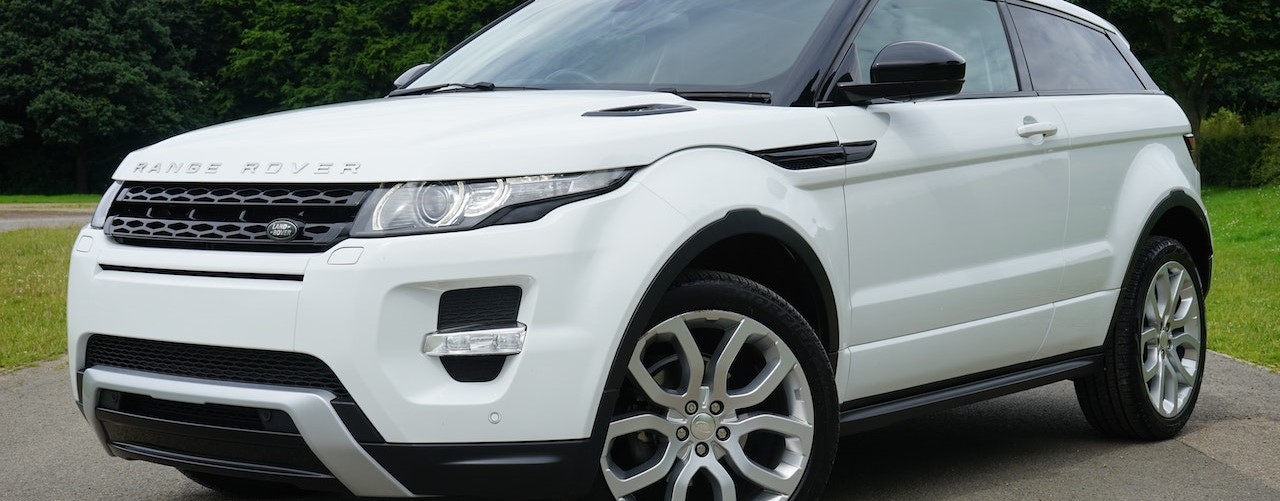 White Land Rover Range Rover Suv on Road | Breast Cancer Car Donations