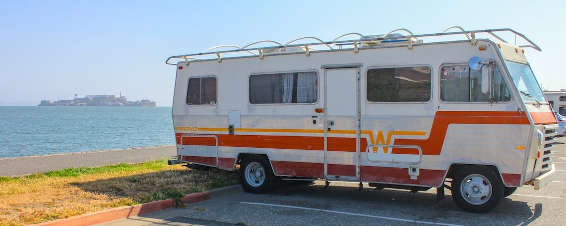 White and Orange RV parked | Breast Cancer Car Donations