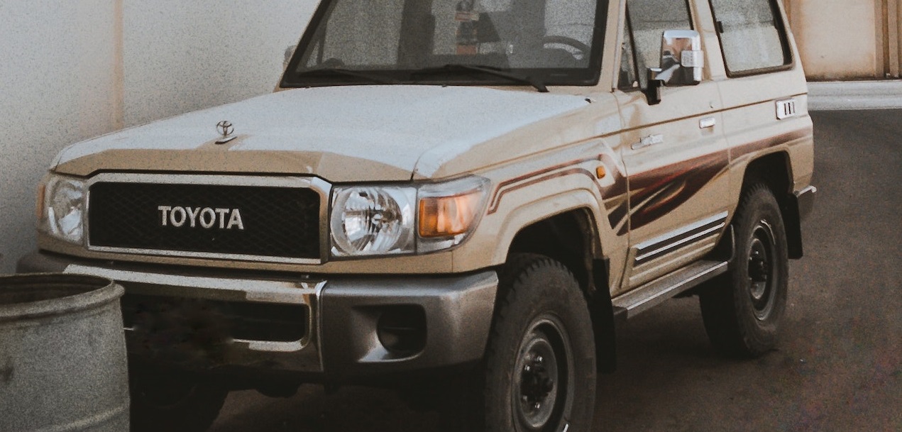 White and brown SUV parked