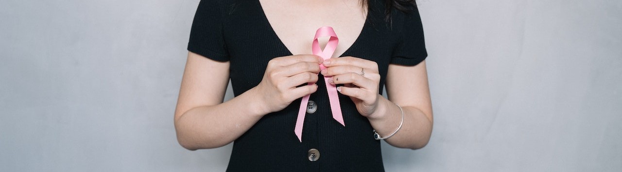 Woman Holding Pink Ribbon | Breast Cancer Car Donations