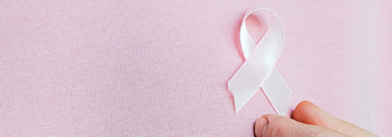 Woman Wearing Pink Ribbon | Breast Cancer Car Donations
