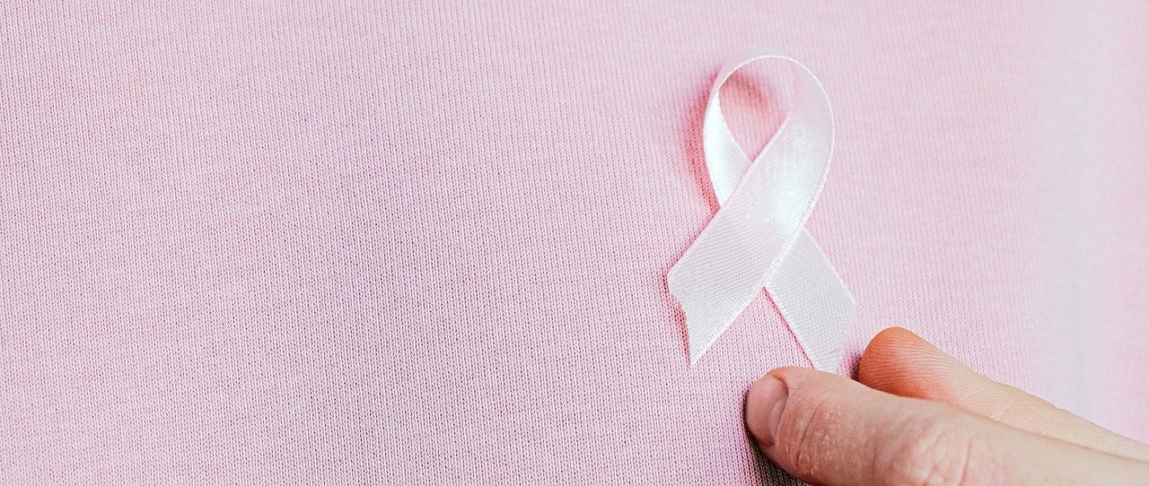 Woman Wearing Pink Ribbon | Breast Cancer Car Donations