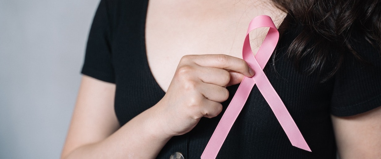 Woman holding Pink ribbon | Breast Cancer Car Donations