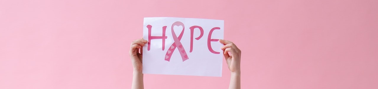 Woman holding a hope sign above the head | Breast Cancer Car Donations