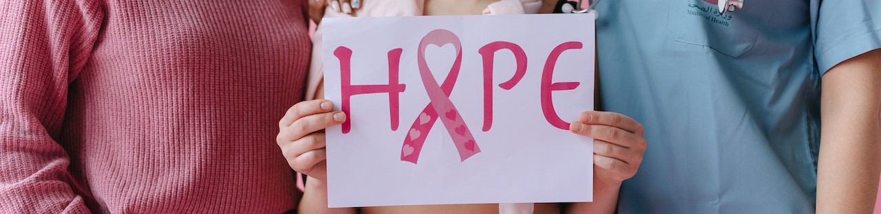 Woman holding a hope sign | Breast Cancer Car Donations