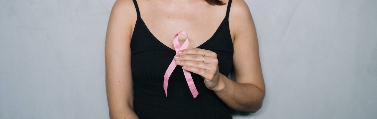 Woman holding pink Ribbon | Breast Cancer Car Donations