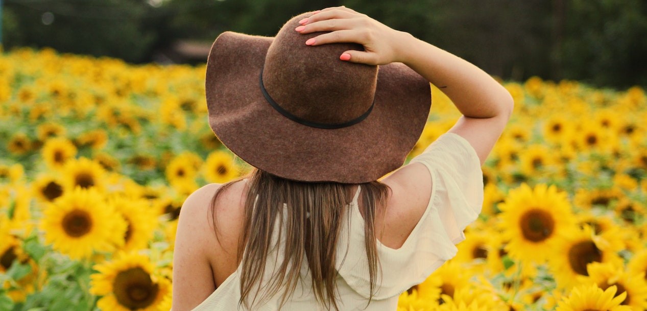 Woman in a Sunflower Field | Breast Cancer Car Donations