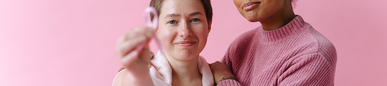 Women in Pink Outfit in a Pink Background | Breast Cancer Car Donations