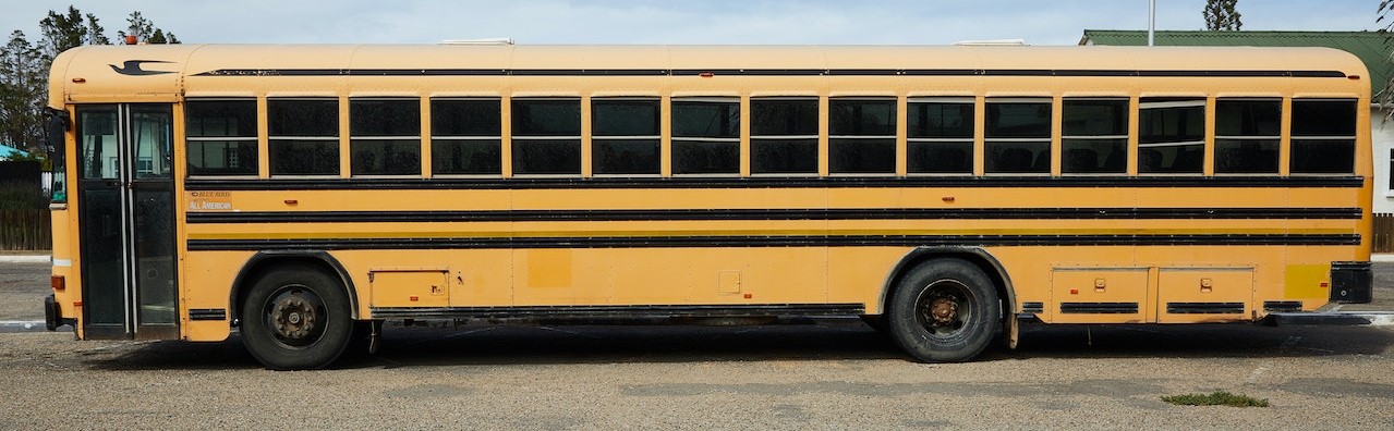 Yellow bus parked | Breast Cancer Car Donations