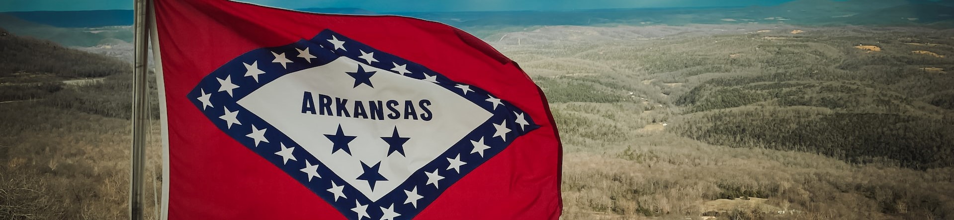 a flag in a field with a sky in the background photo | Breast Cancer Car Donations